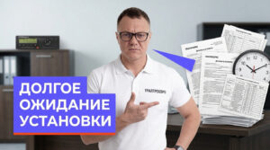 Специалист устанавливает тахограф в кабине грузового транспортного средства